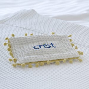 Pillow product with Crist's logo over it